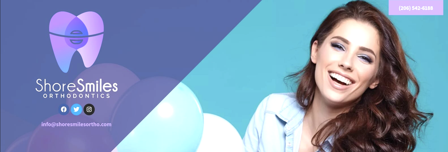 A person with blue balloons smiling